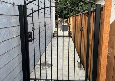 Custom side yard iron gate with detailed finishes for Portland home by Kervin Ironworks