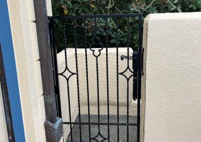 Moorish iron gate creates a beautiful accent in the yard